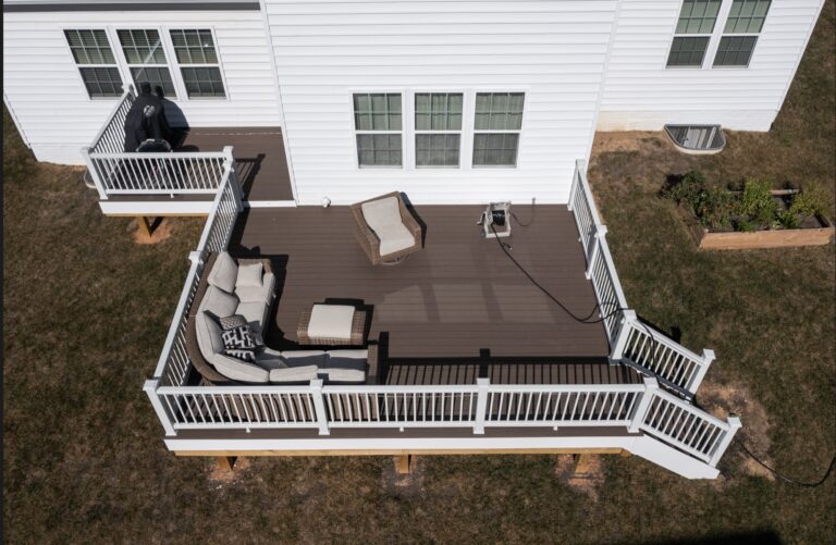 Dark composite deck with white rail and built-in seating — Fredericksburg Deck Builders