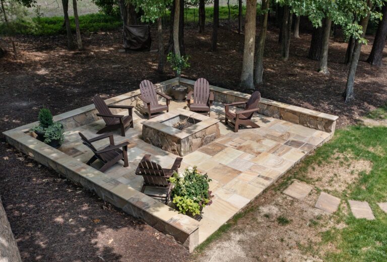 Flagstone patio with stone seat walls and a stone fire pit — hardscape by Fredericksburg Deck Builders, Fredericksburg VA