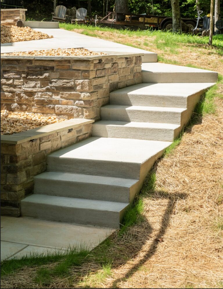 Stone retaining wall with concrete stairs connecting the driveway to the backyard — hardscape by Fredericksburg Deck Builders, Fredericksburg VA