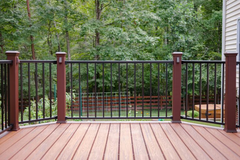 Brown deck rail posts with black balusters — deck railing by Fredericksburg Deck Builders, Fredericksburg VA