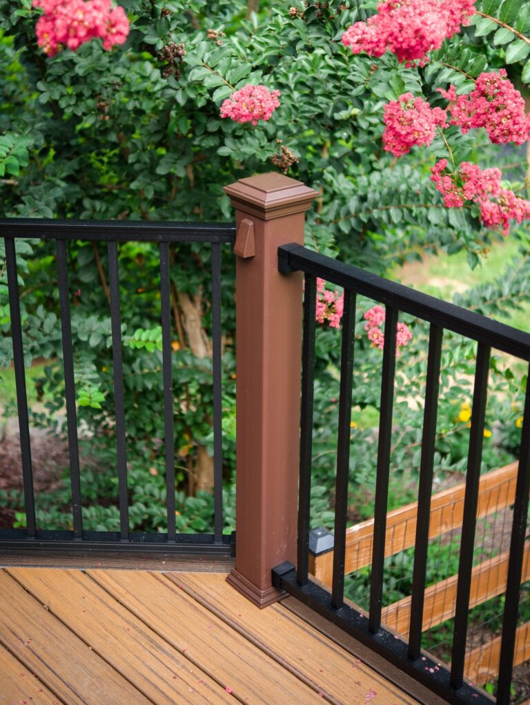 Brown rail post with black balusters, detail — deck railing by Fredericksburg Deck Builders, Fredericksburg VA