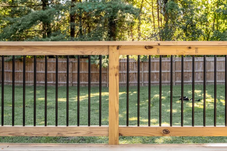 Wood rail frame with black balusters — deck railing by Fredericksburg Deck Builders, Fredericksburg VA