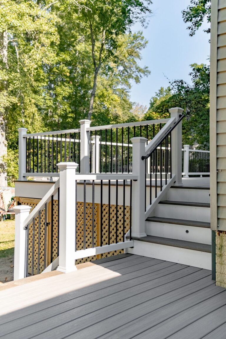 White stair railing with black balusters — deck railing by Fredericksburg Deck Builders, Fredericksburg VA