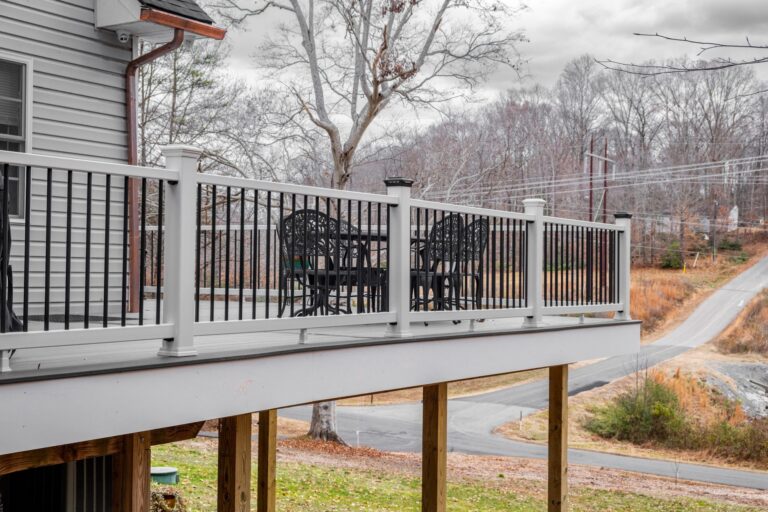 White railing with black balusters on an elevated deck — deck railing by Fredericksburg Deck Builders, Fredericksburg VA