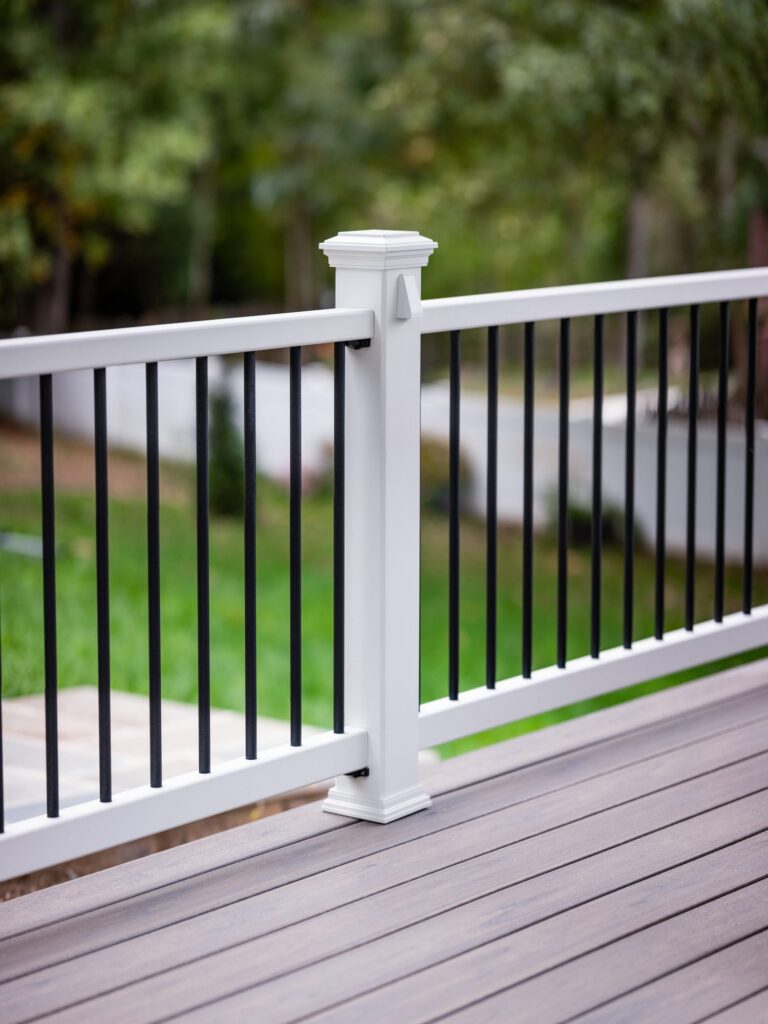 White rail post with black balusters, detail — deck railing by Fredericksburg Deck Builders, Fredericksburg VA